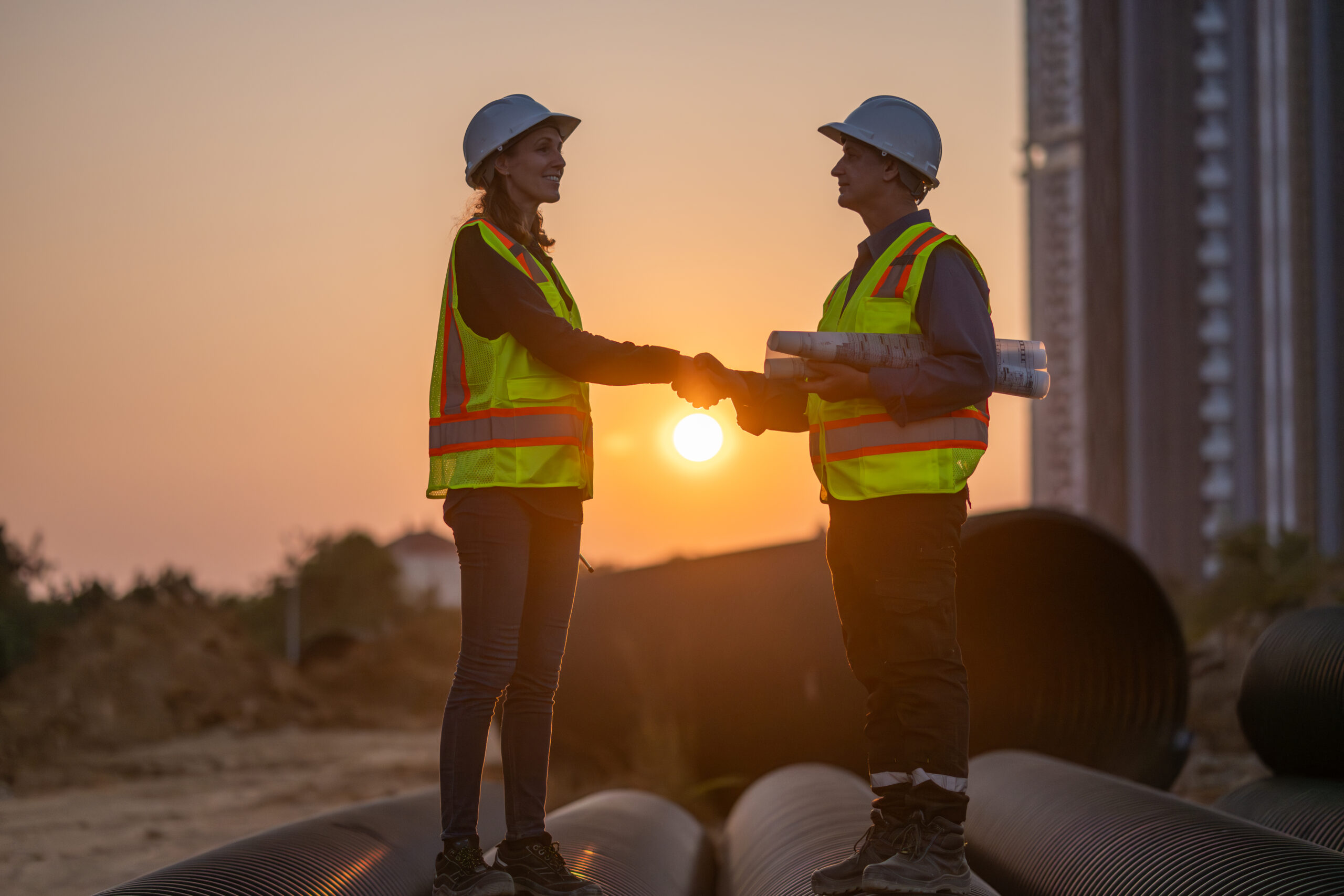 Construction surveyor or engineer working in pipe construction s
