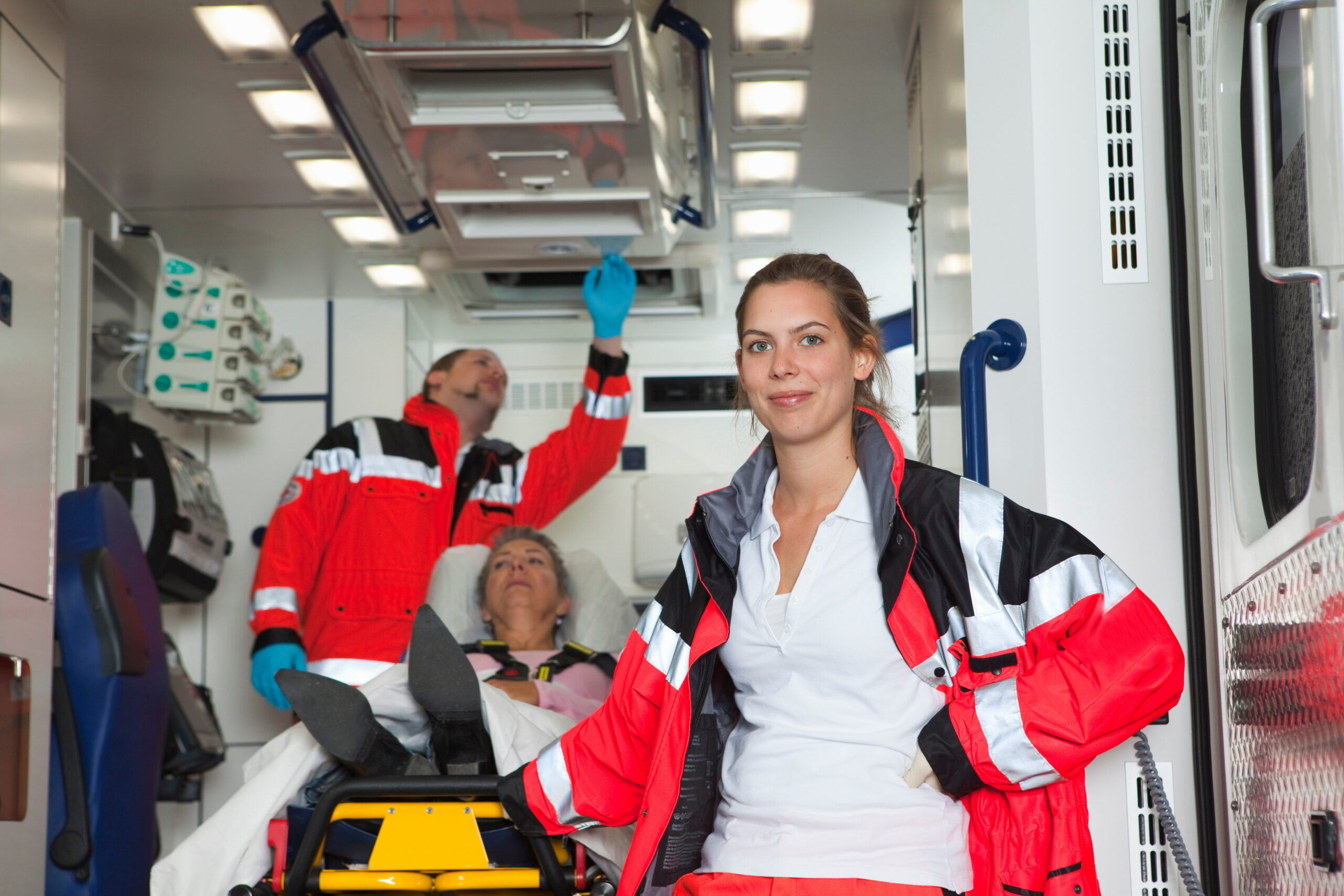 Ambulance team with patient in coach