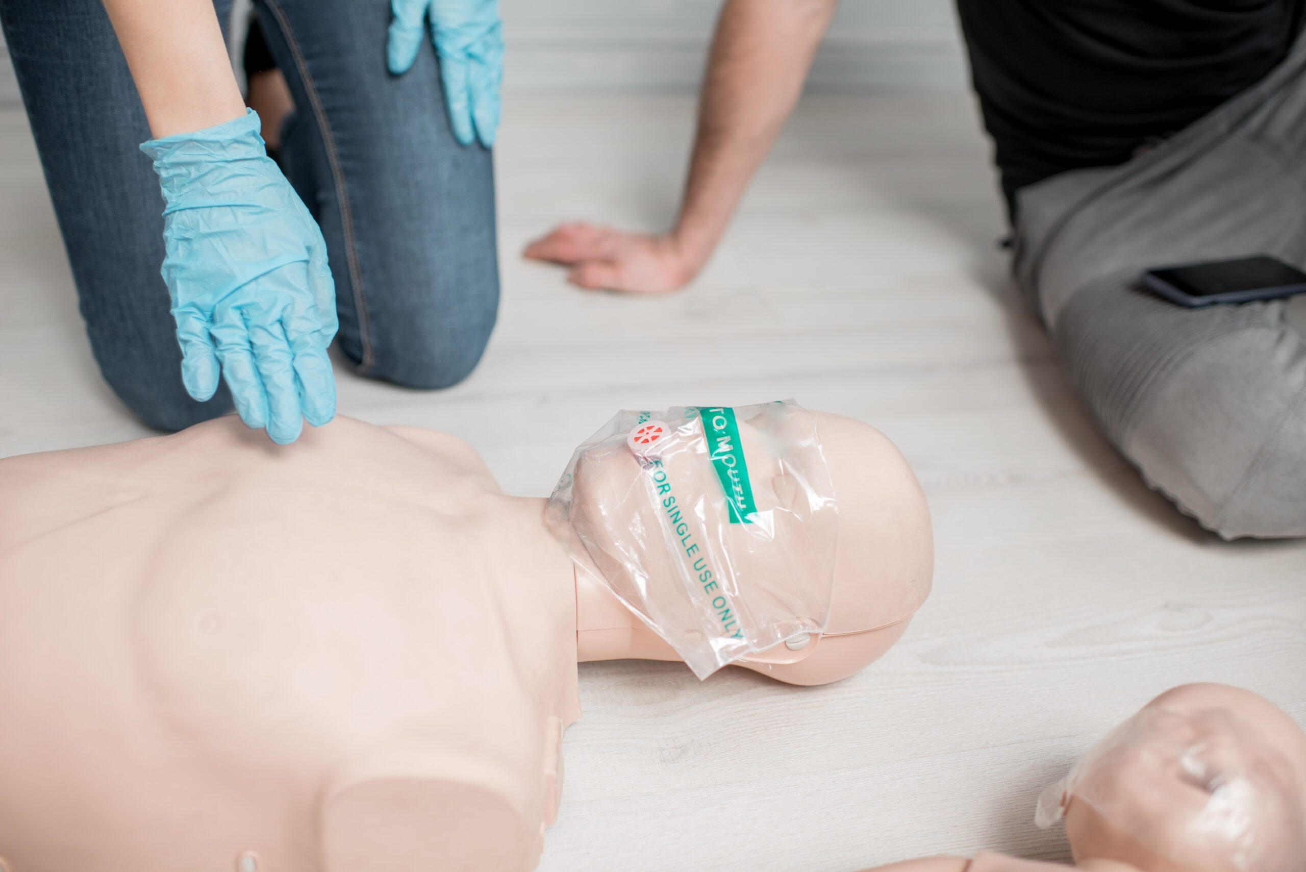Mask with valve for artificial respiration on a dummy during the first aid training indoors