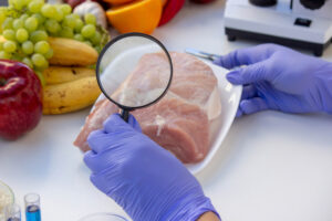 Meat and Food Quality Control Laboratory Testing with a Magnifying Glass. world food safety day