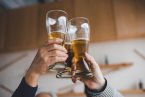 cropped shot of friends clinking glasses international beer day