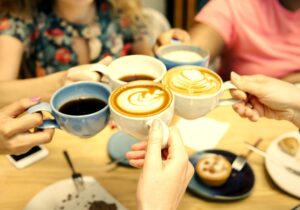 Friends having coffee at a cafe international coffee day