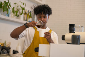 young-male-barista-carefully-pouring-coffee-into-a-cup is it espresso or expresso