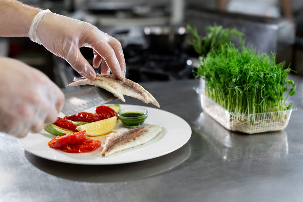 Chef puts the fish on a plate Australian Food Safety Week 2026, Food Safety Advice, And The Importance of Reading Food Labels for Safer Food