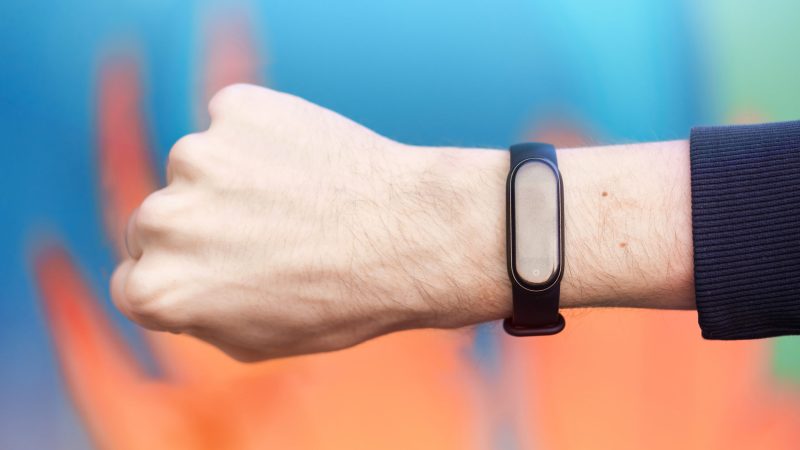 A male hand clenched into a fist with medic alert bracelet