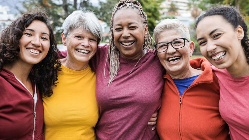 Happy multi generational women having fun together - Multiracial friends smiling on camera after sport workout outdoor - Main focus on african female face Women's Health Week 2026