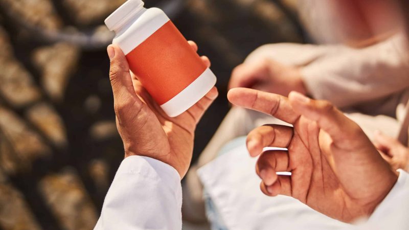 man holding jar of blood thinners