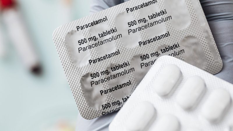 Hand holding paracetamol medicine packets