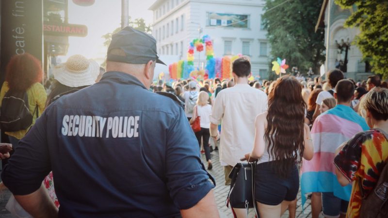 security crowd control worker guard on street busy festival parade