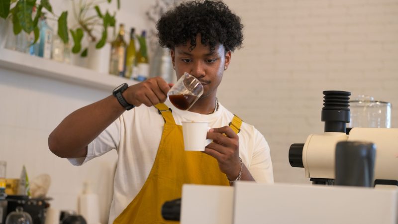 young-male-barista-carefully-pouring-coffee-into-a-cup is it espresso or expresso